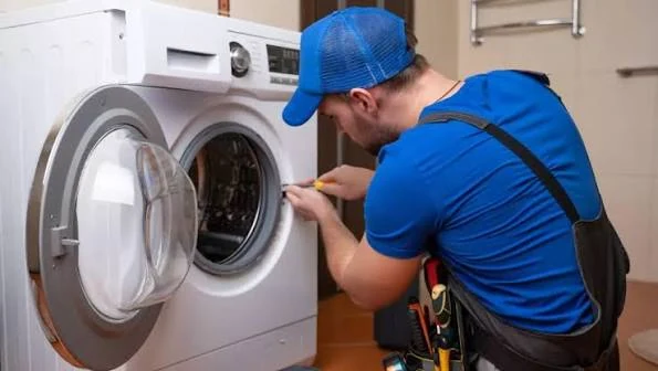 Technician examining the drum and door opening of a washing machine